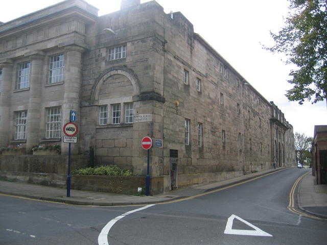 Warwick Old Gaol. An old prison door has been set in to the wall close to the corner of the building, just to the right of the no entry sign to commemorate the building's former use. © Copyright David Stowell and licensed for reuse under this Creative Commons Licence